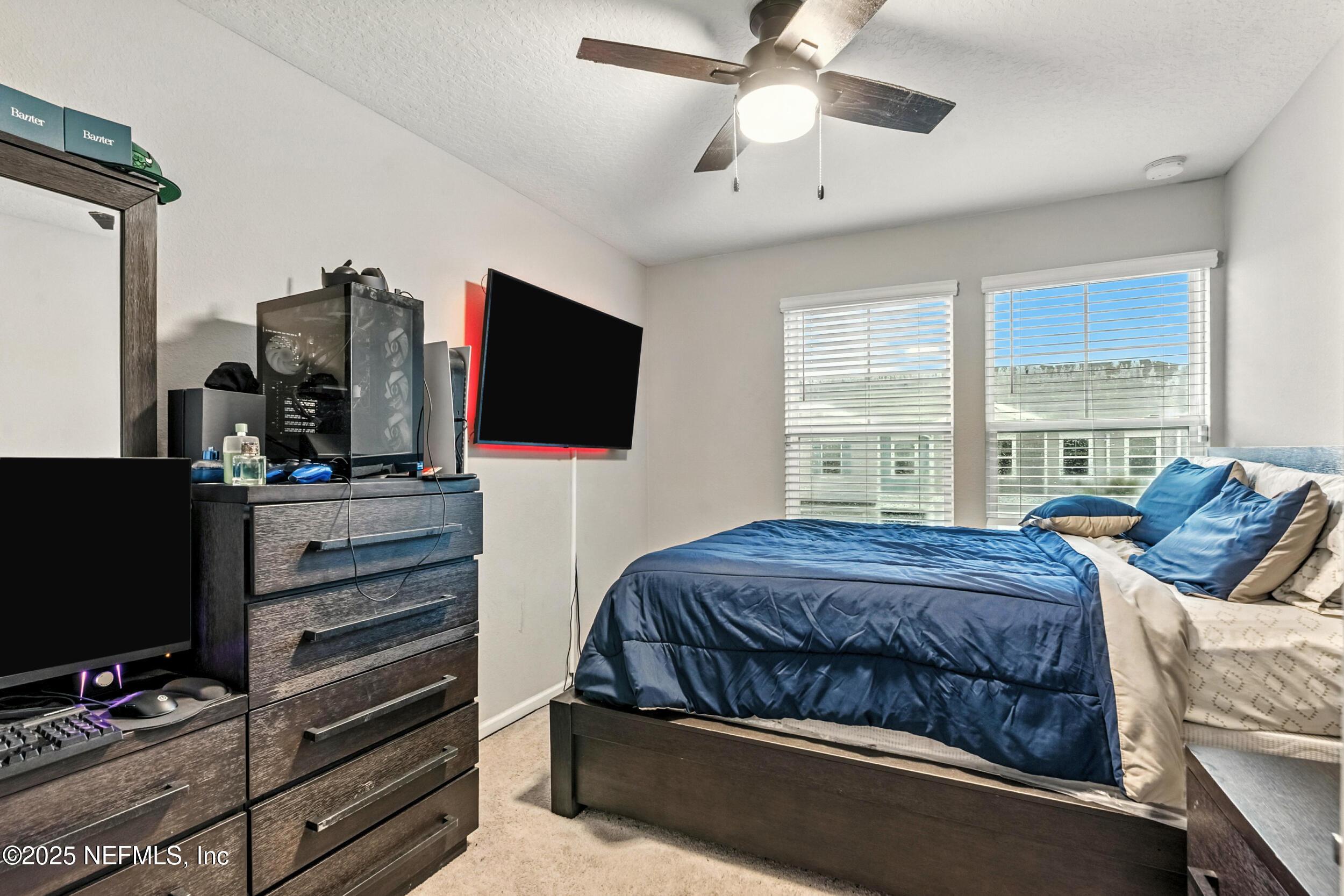 1330 Salt Ridge Avenue Jacksonville, FL 32218 - Photo 20 of 27 a bedroom with a bed and a flat screen tv