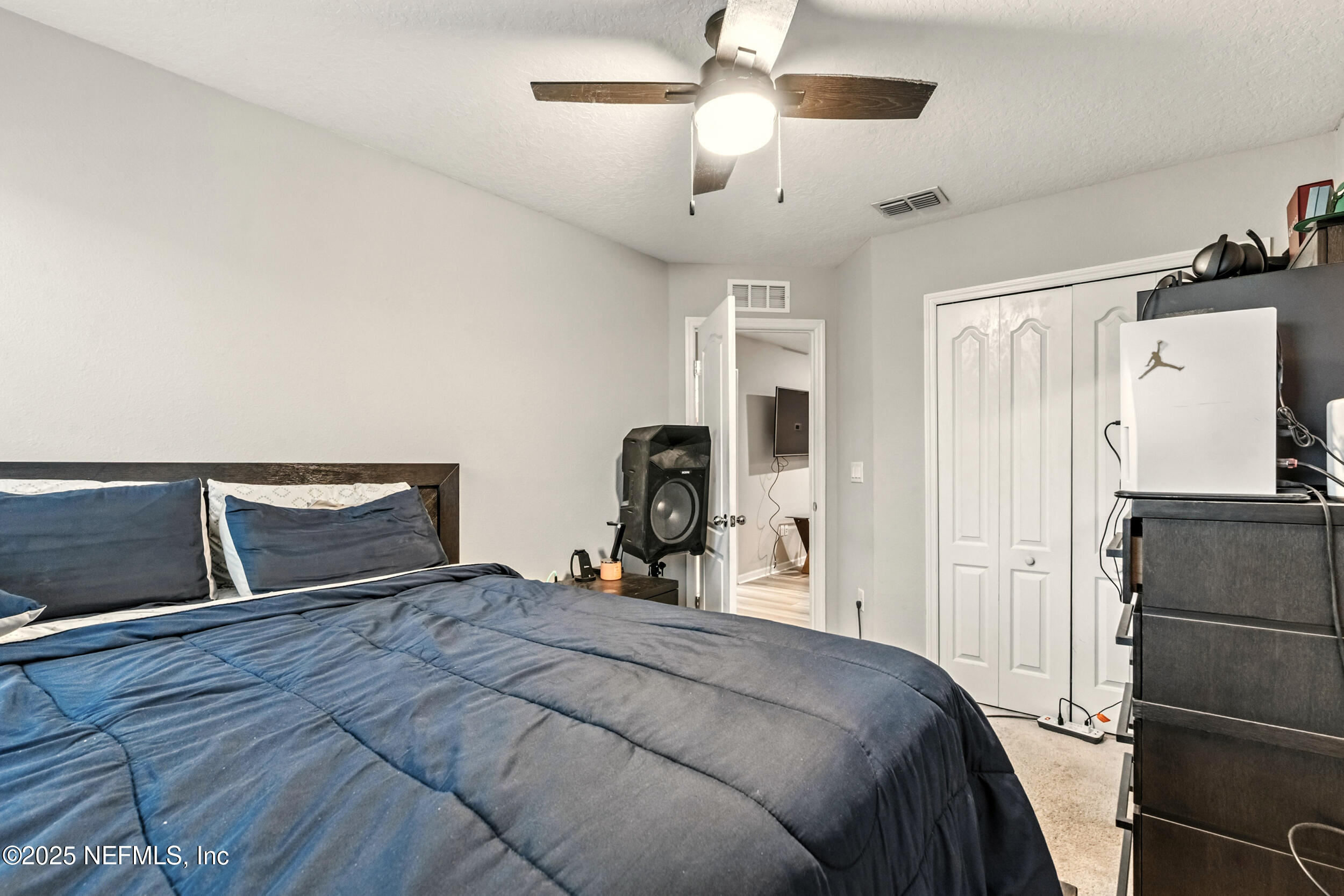 1330 Salt Ridge Avenue Jacksonville, FL 32218 - Photo 21 of 27 a bedroom with a bed and a chandelier