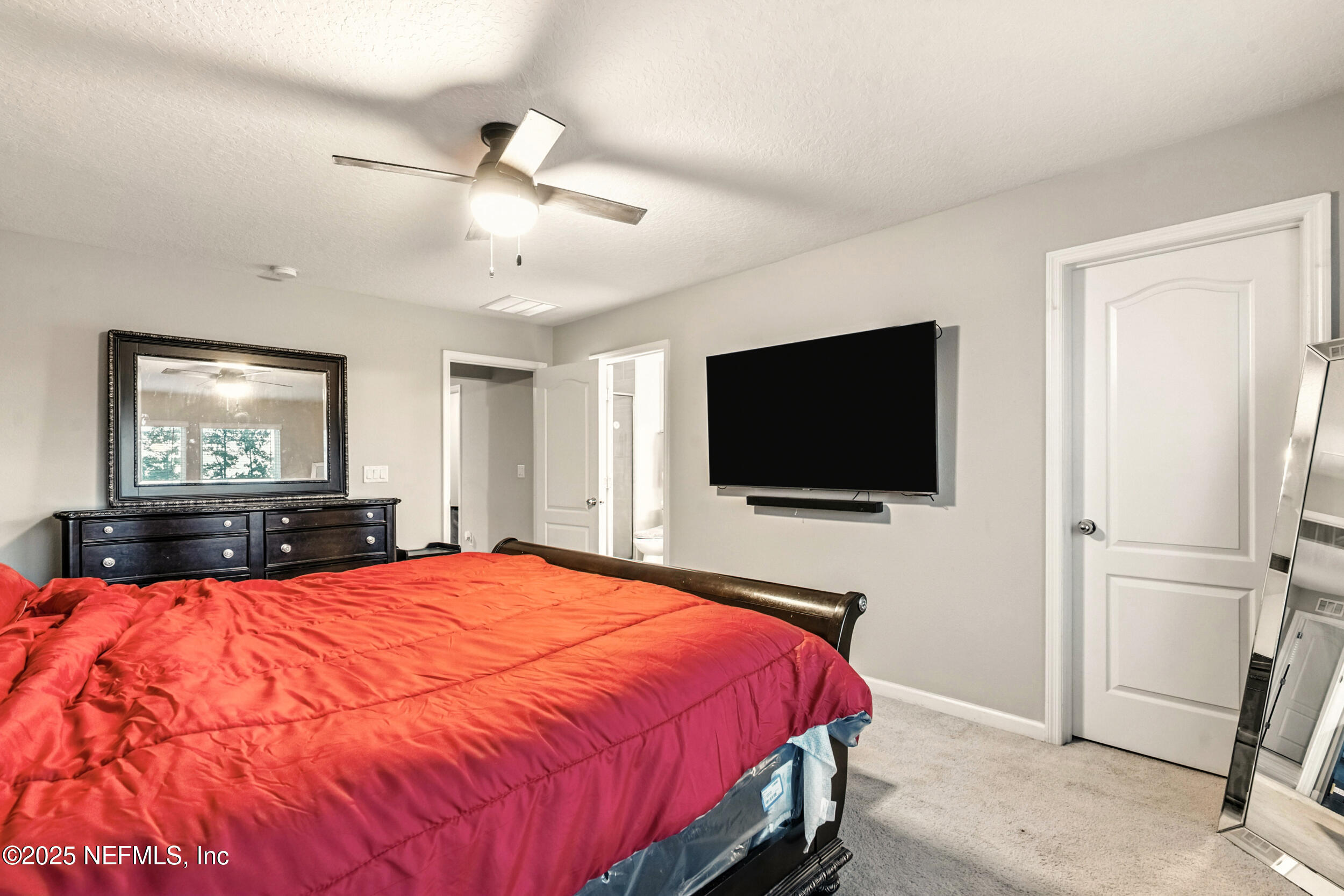 1330 Salt Ridge Avenue Jacksonville, FL 32218 - Photo 21 of 30 a bedroom with a bed and a flat screen tv