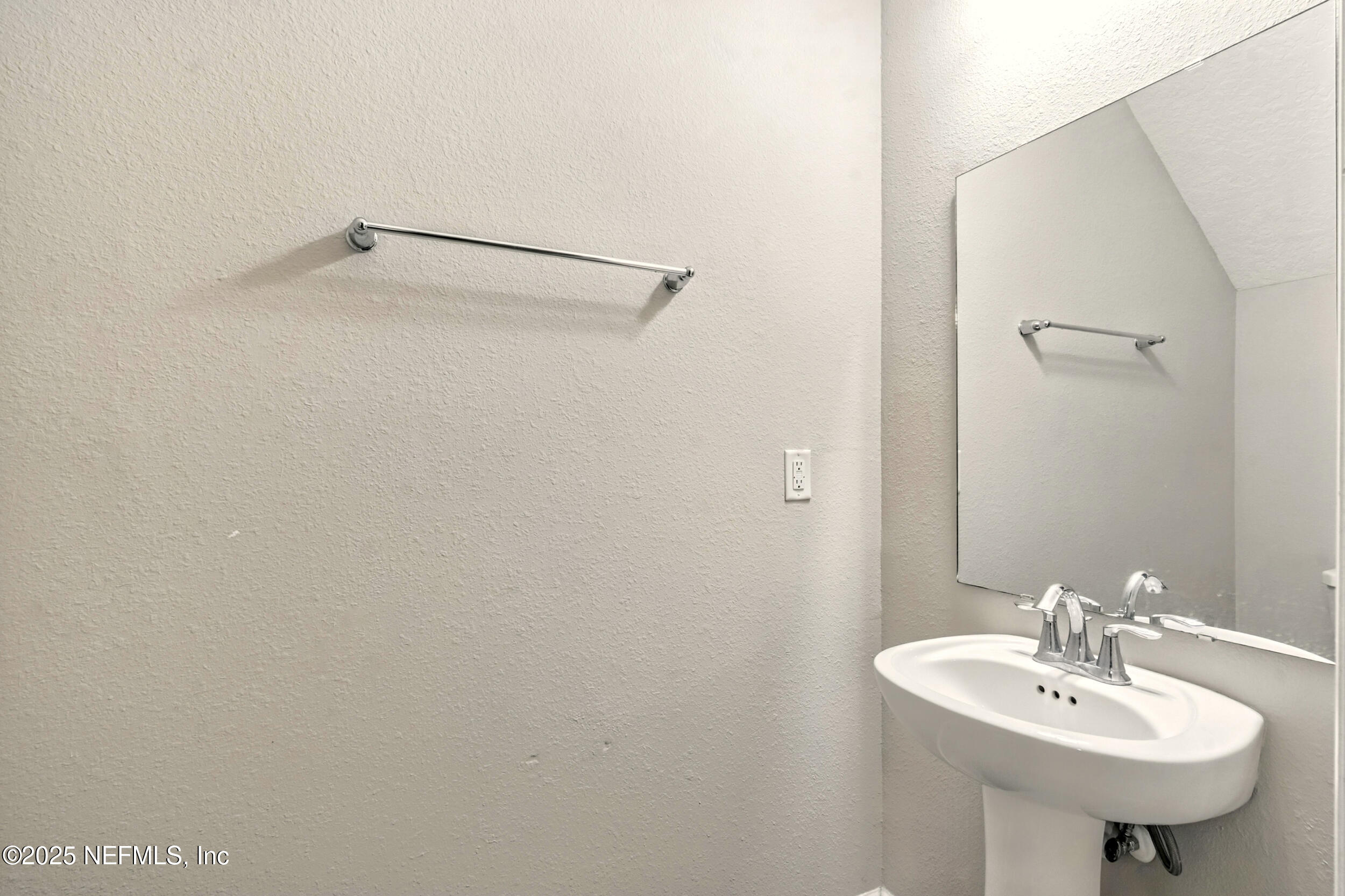1330 Salt Ridge Avenue Jacksonville, FL 32218 - Photo 22 of 27 a bathroom with a sink and a mirror