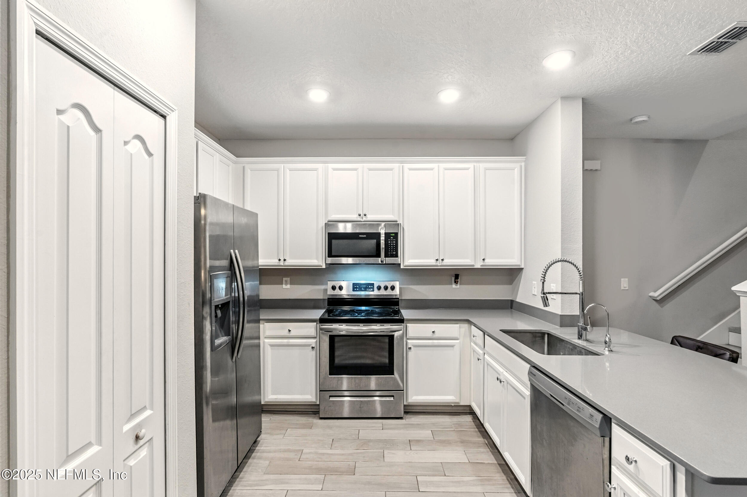 1330 Salt Ridge Avenue Jacksonville, FL 32218 - Photo 8 of 27 a kitchen with stainless steel appliances granite countertop a stove a sink and a refrigerator