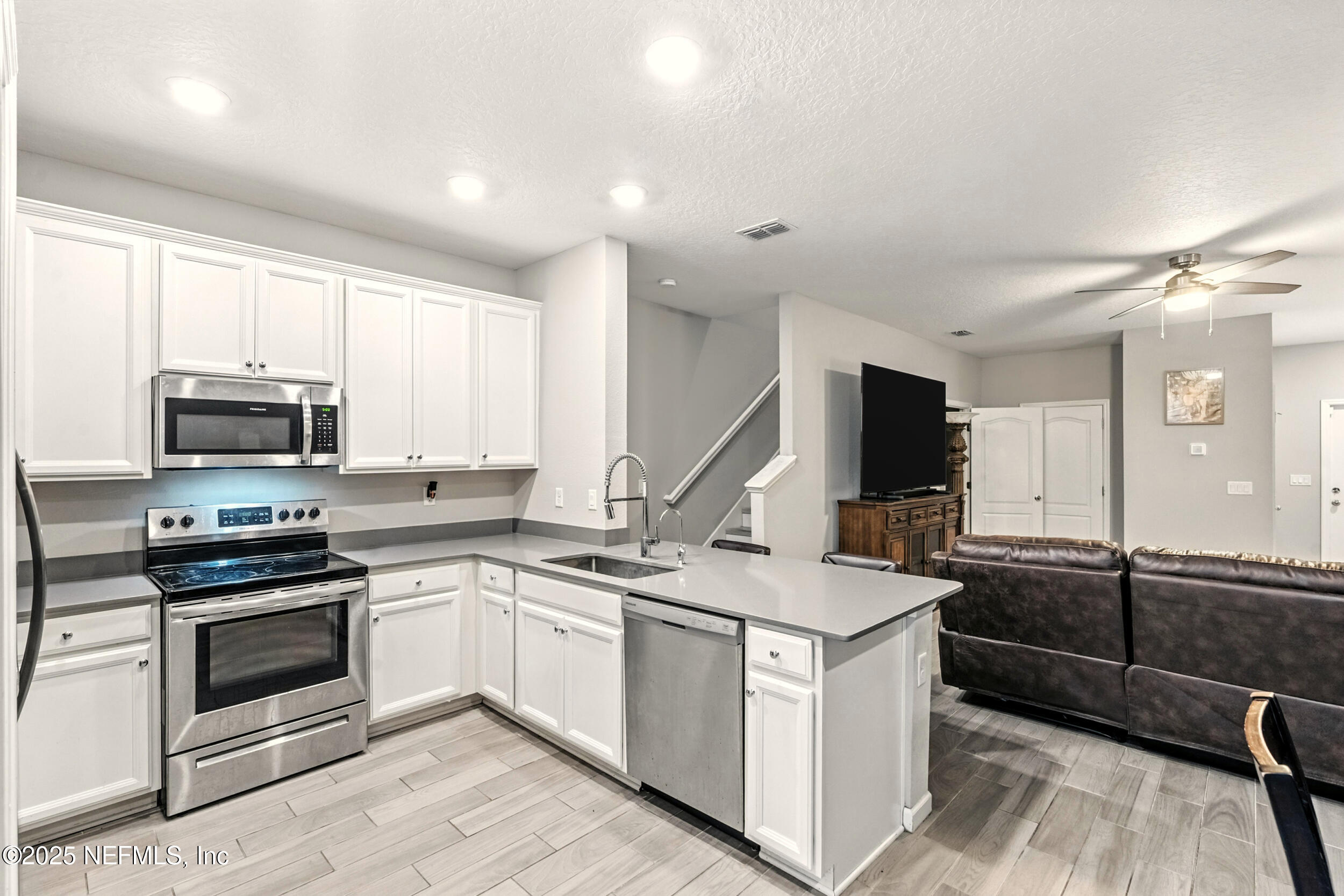 1330 Salt Ridge Avenue Jacksonville, FL 32218 - Photo 9 of 27 a kitchen that has a sink a stove and cabinets