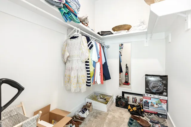 a spacious bedroom with a bed and a flat screen tv