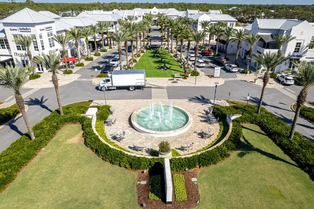 a view of a swimming pool with outdoor seating and plants