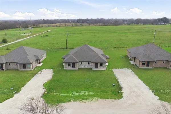 a aerial view of a house with big yard