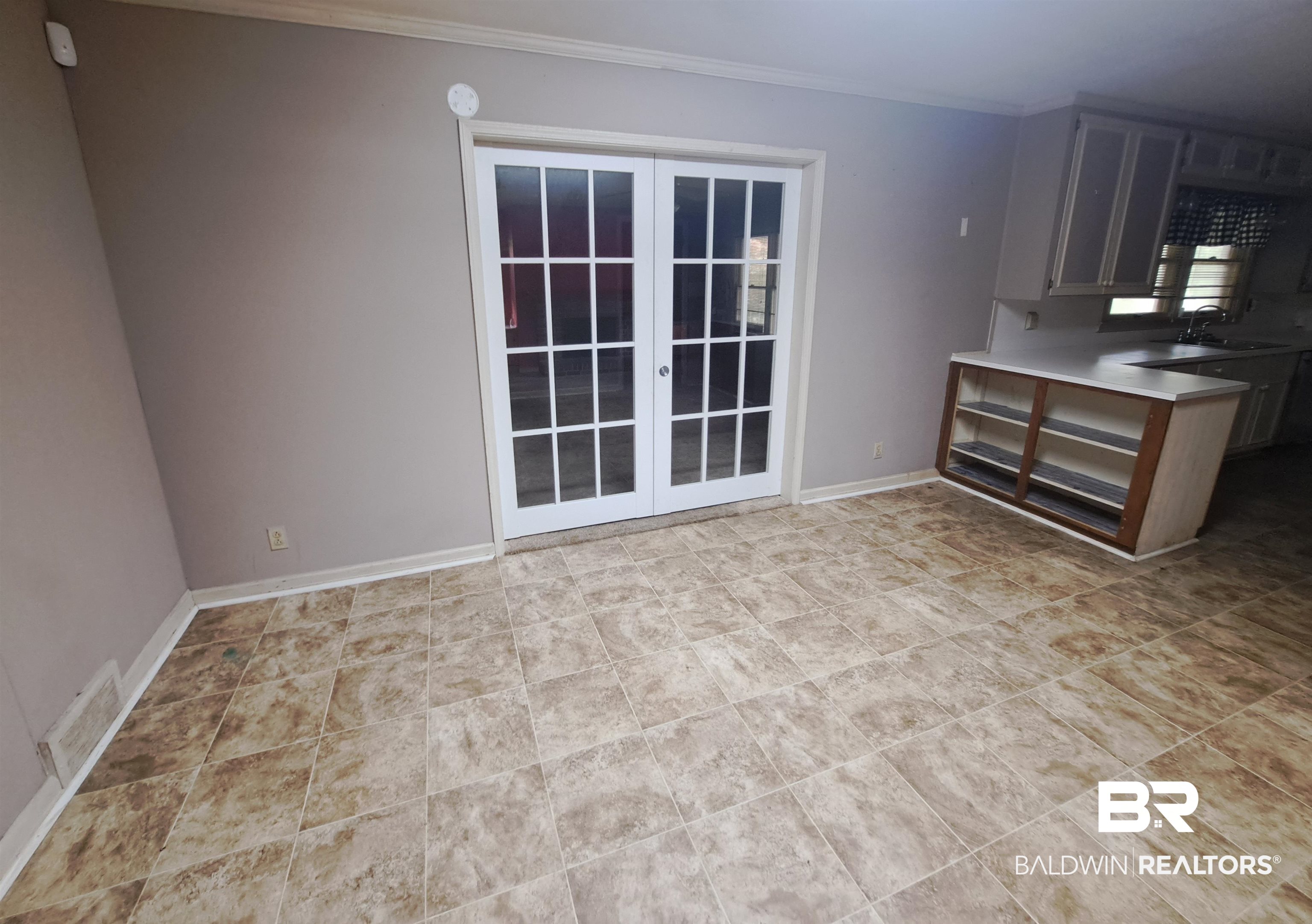 249 Newton Parkway Evergreen, AL 36401 - Photo 17 of 28 Unfurnished dining area featuring baseboards and crown molding