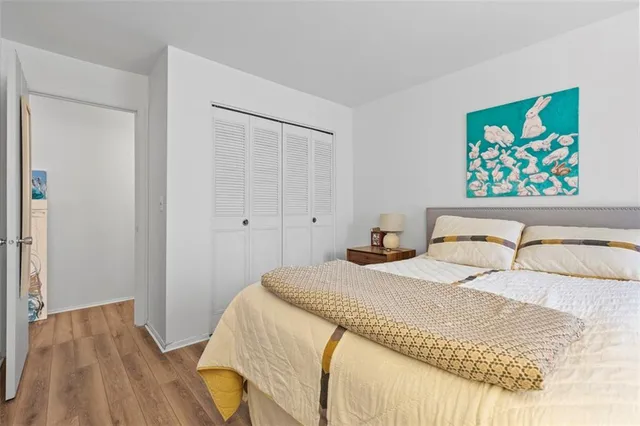 a bedroom with a bed and a painting on the wall