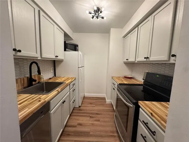 a kitchen with stainless steel appliances granite countertop a stove and a sink