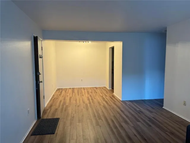 a view of a room with wooden floor and iron gate