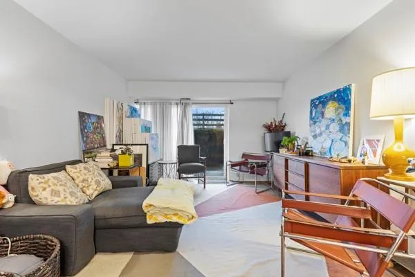 a living room with furniture fireplace and a window