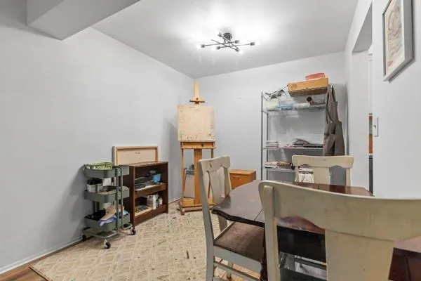 a view of a workspace with furniture and a window