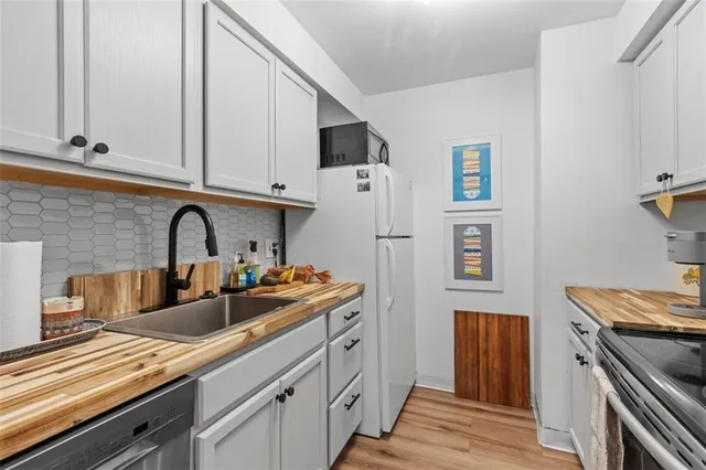 a kitchen with stainless steel appliances a sink and a refrigerator