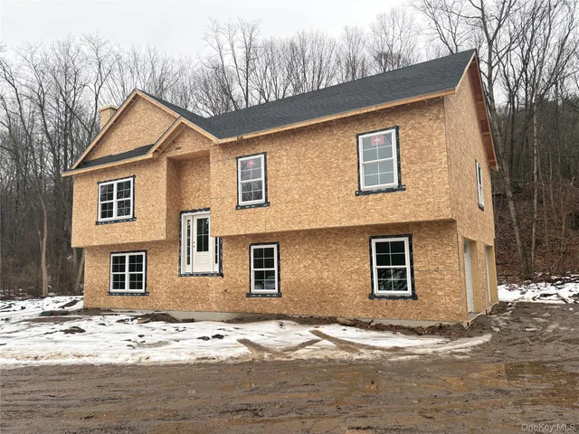 a view of a house with snow on the road