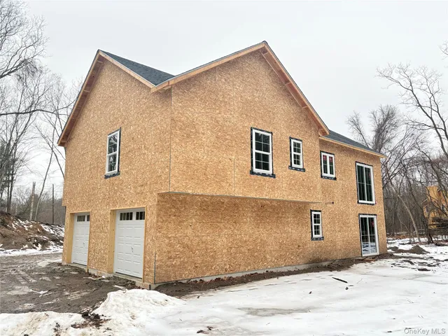 a house that has a tree in front of it