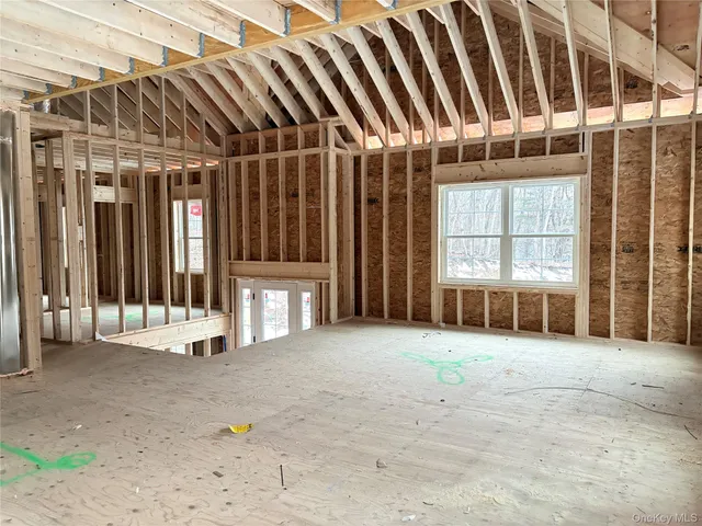 an empty room with large windows