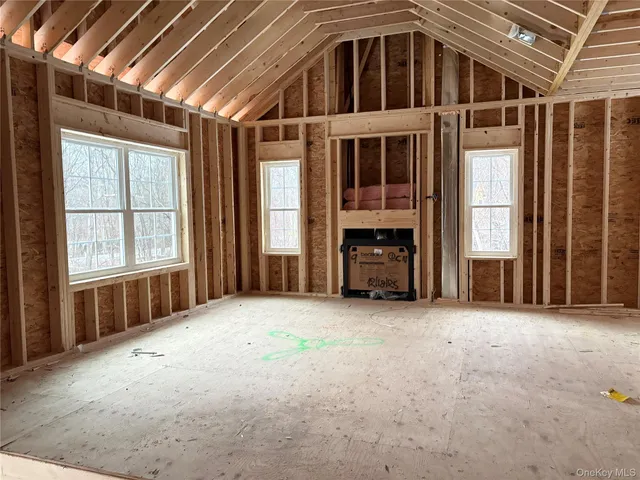 a view of an empty room with large windows