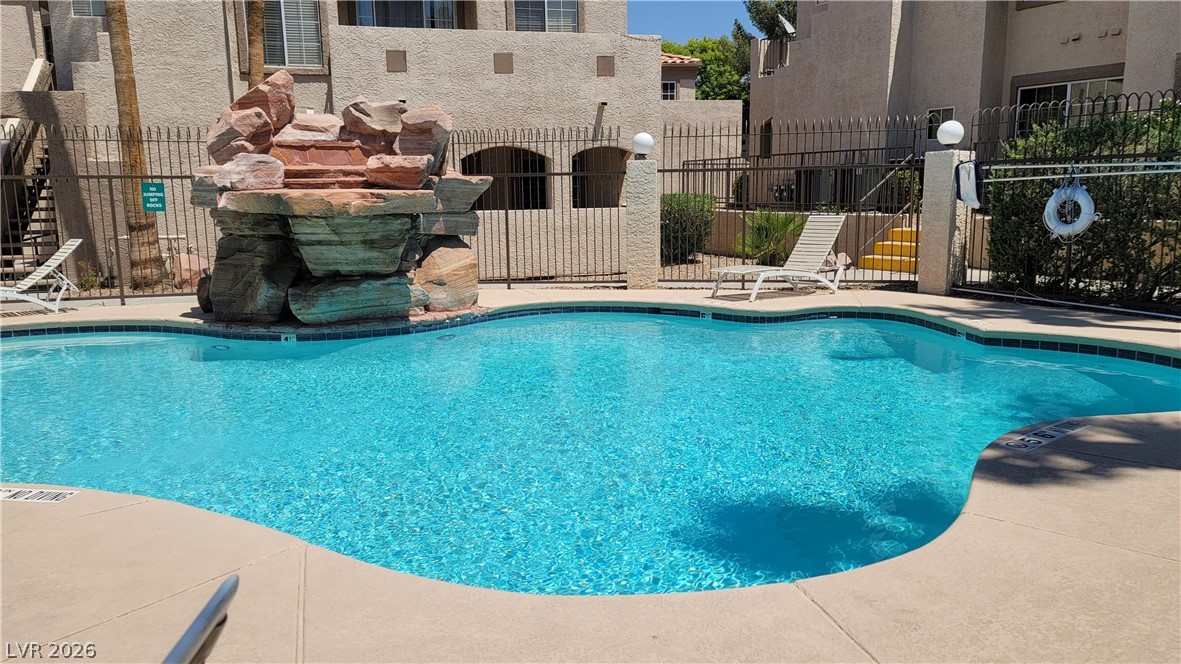 A refreshing outdoor pool, adorned with natural rock features, offers a serene escape.