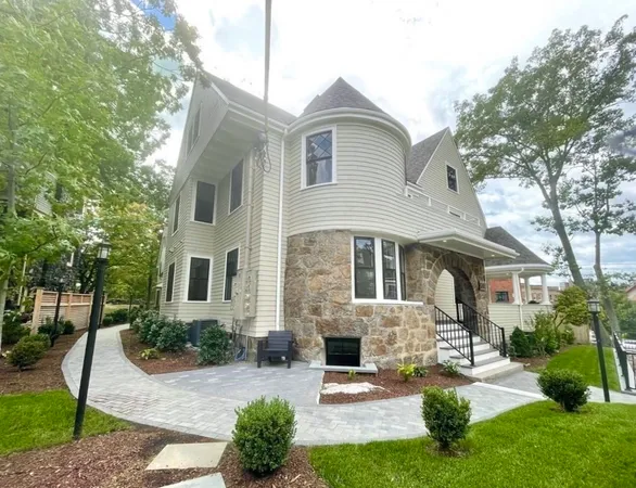 a front view of a house with yard and green space