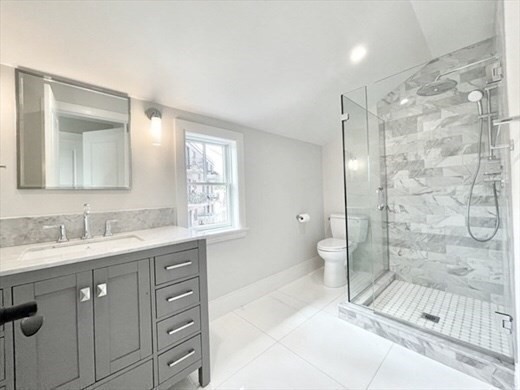 24 Selkirk Road, Unit 244 Boston, MA 02135 - Photo 11 of 31 a bathroom with a double vanity sink toilet mirror and shower