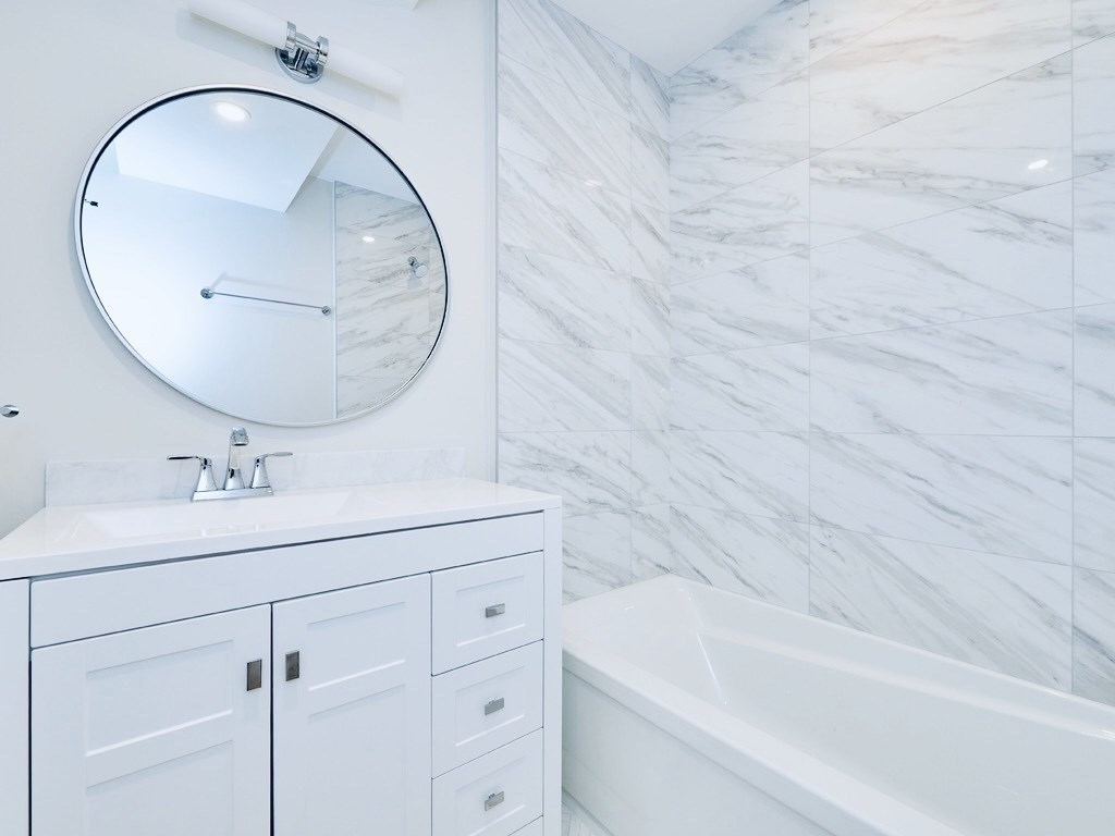 24 Selkirk Road, Unit 244 Boston, MA 02135 - Photo 14 of 31 a bathroom with a sink and a mirror