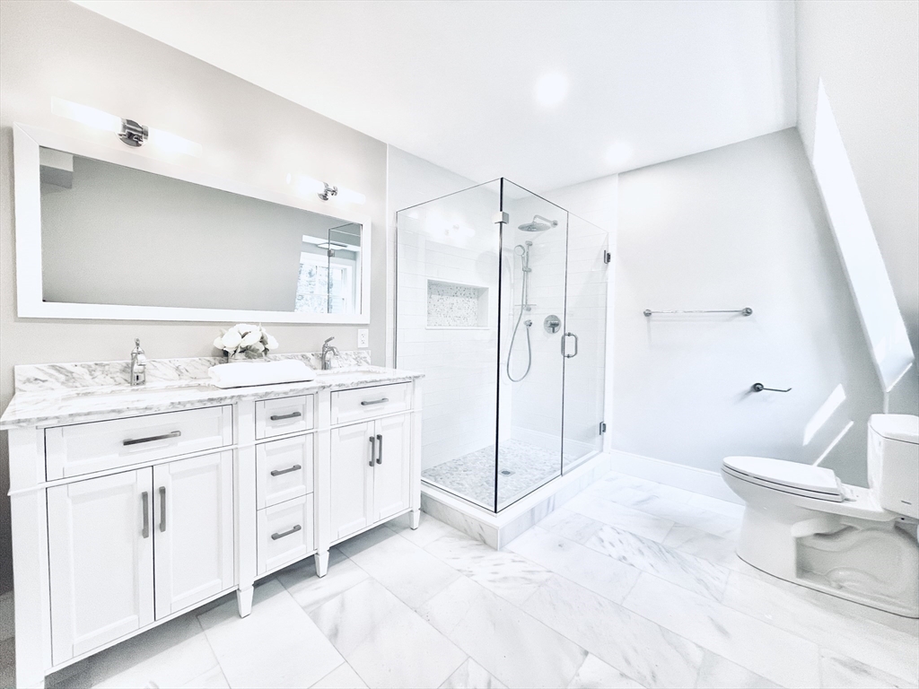 24 Selkirk Road, Unit 244 Boston, MA 02135 - Photo 17 of 31 a bathroom with a double vanity sink mirror and toilet