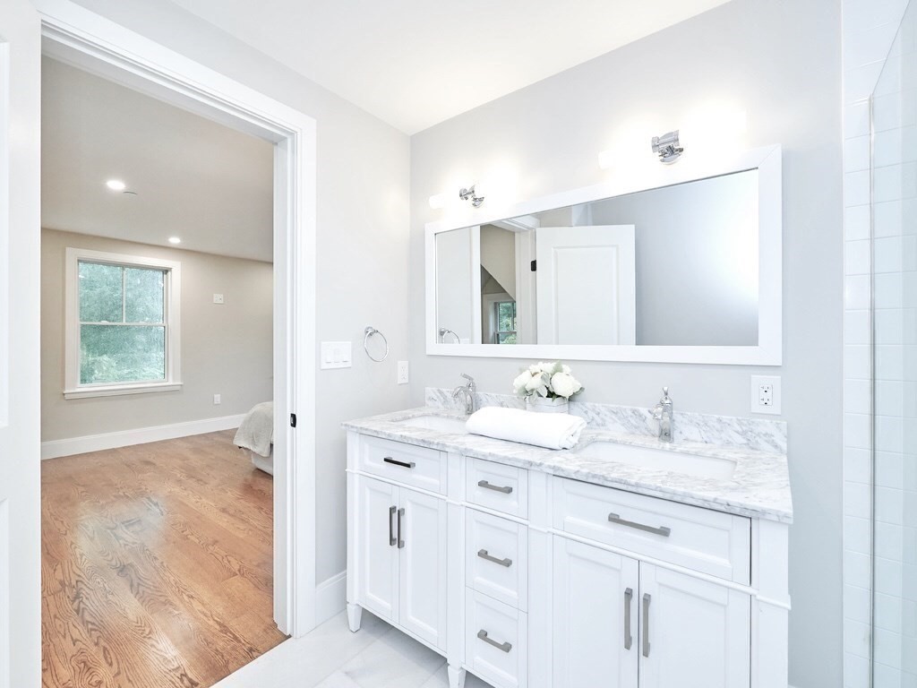 24 Selkirk Road, Unit 244 Boston, MA 02135 - Photo 18 of 31 a bathroom with a granite countertop sink mirror and double