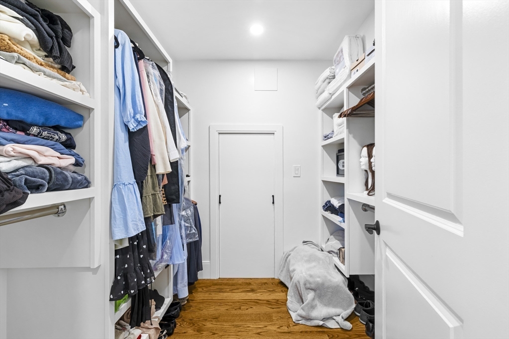 24 Selkirk Road, Unit 244 Boston, MA 02135 - Photo 19 of 31 a view of walk in closet with clothes and shoes