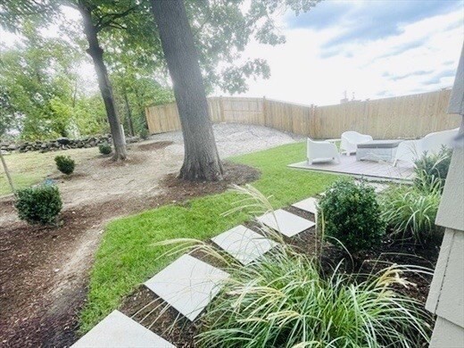 24 Selkirk Road, Unit 244 Boston, MA 02135 - Photo 25 of 31 a view of a yard with plants and a bench