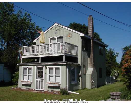 67 Chalker Beach Road Old Saybrook, CT 06475 - Photo 1 of 1 a front view of a house with a yard