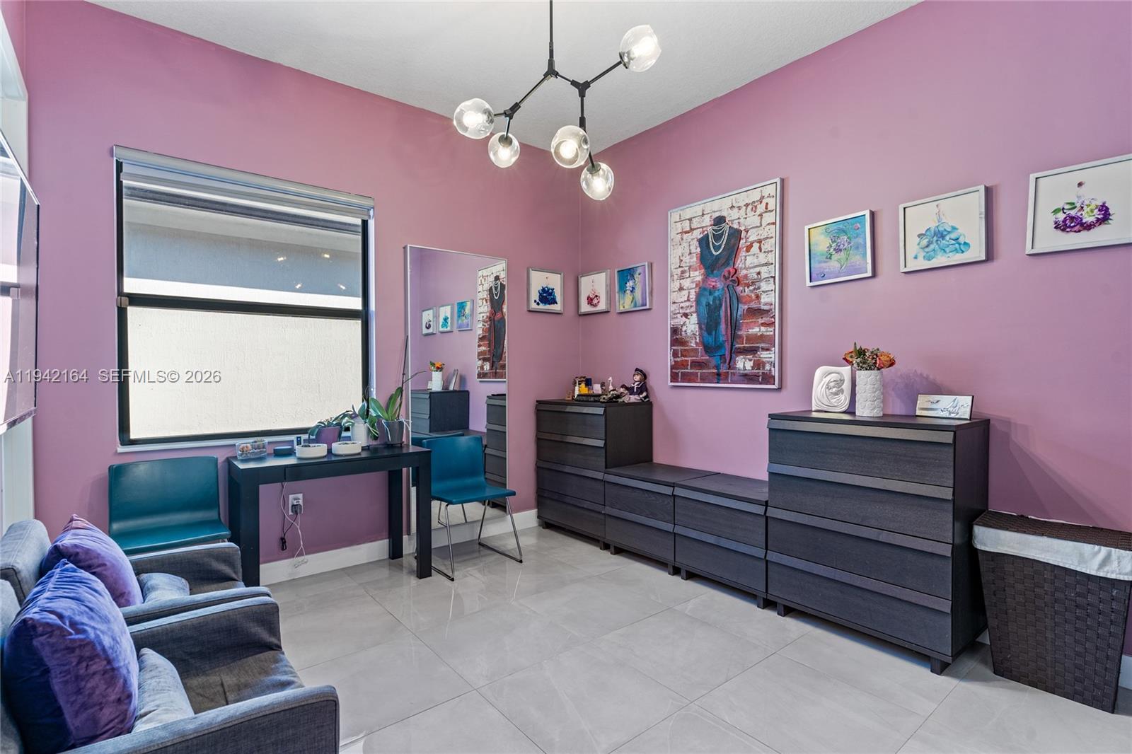 17375 Southwest 41st Street Miramar, FL 33029 - Photo 23 of 53 a living room with furniture and a chandelier