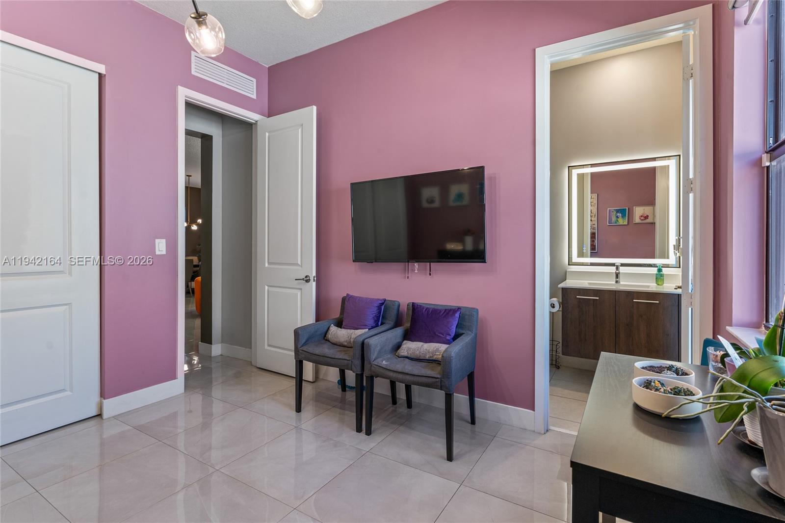 17375 Southwest 41st Street Miramar, FL 33029 - Photo 24 of 53 a living room with furniture and a flat screen tv