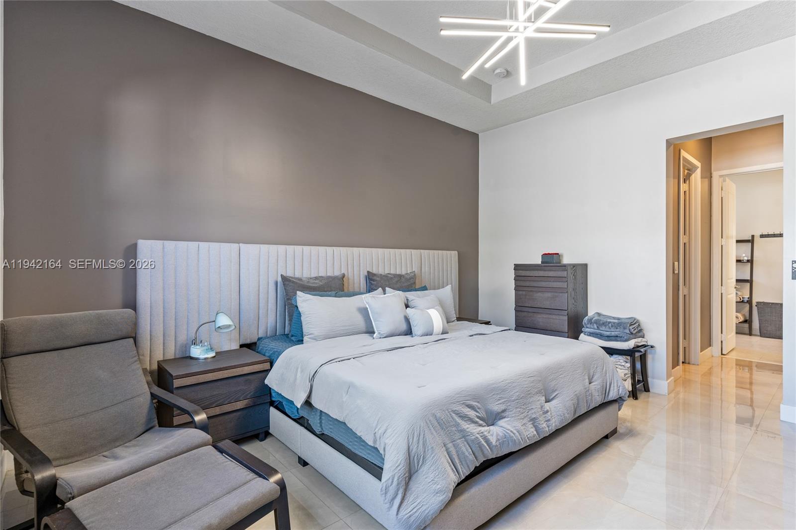 17375 Southwest 41st Street Miramar, FL 33029 - Photo 28 of 53 a bedroom with a bed and a chandelier