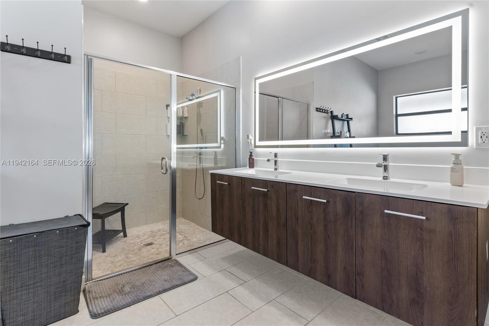 17375 Southwest 41st Street Miramar, FL 33029 - Photo 30 of 53 a bathroom with a double vanity sink a mirror and a shower