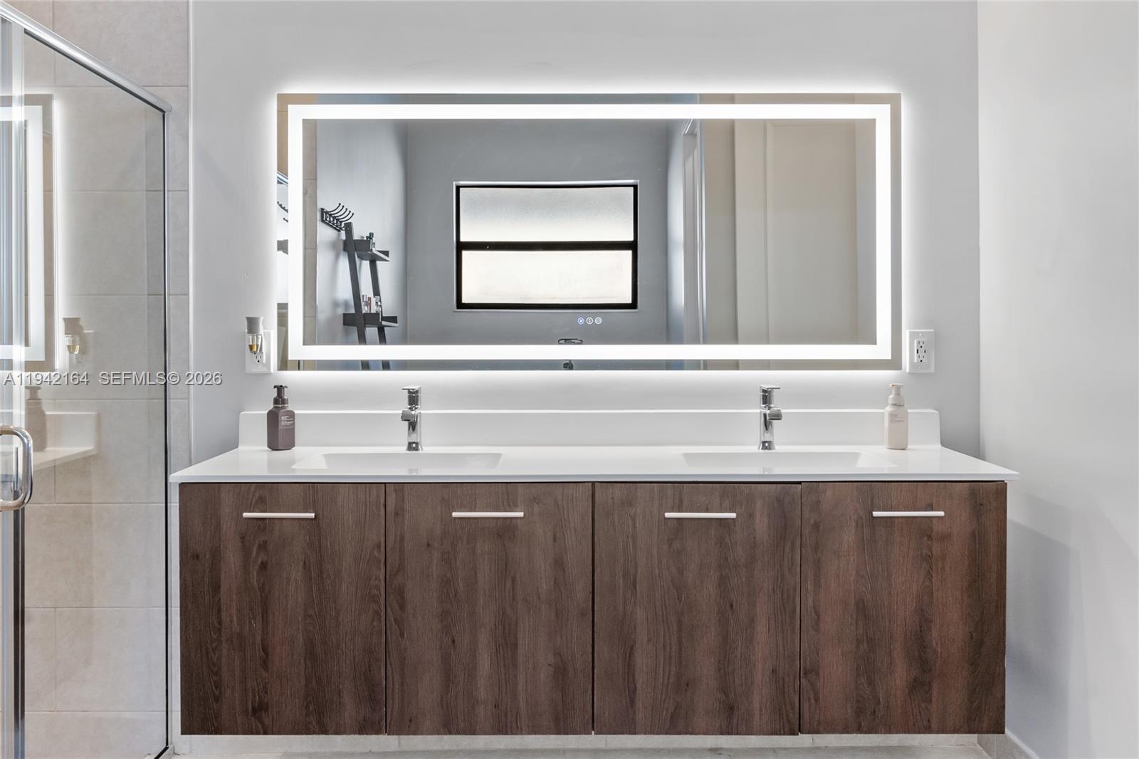 17375 Southwest 41st Street Miramar, FL 33029 - Photo 32 of 53 a bathroom with a granite countertop sink and a mirror