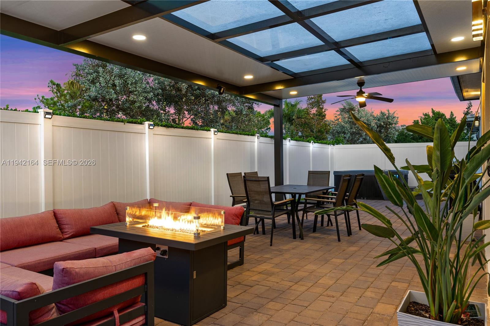 17375 Southwest 41st Street Miramar, FL 33029 - Photo 46 of 53 a view of a patio with table and chairs potted plants and floor to ceiling window