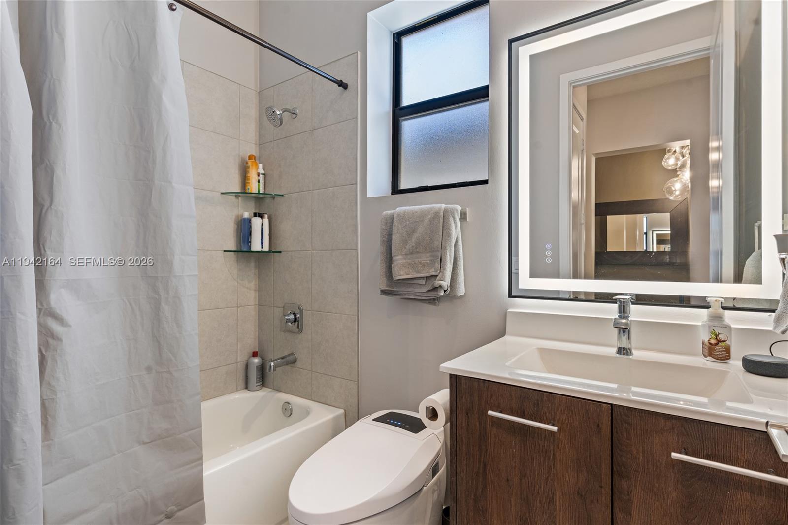 17375 Southwest 41st Street Miramar, FL 33029 - Photo 6 of 53 a bathroom with a sink a toilet and shower a mirror