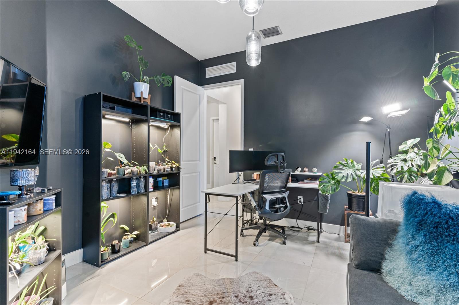 17375 Southwest 41st Street Miramar, FL 33029 - Photo 7 of 53 a workspace with furniture and a flat screen tv
