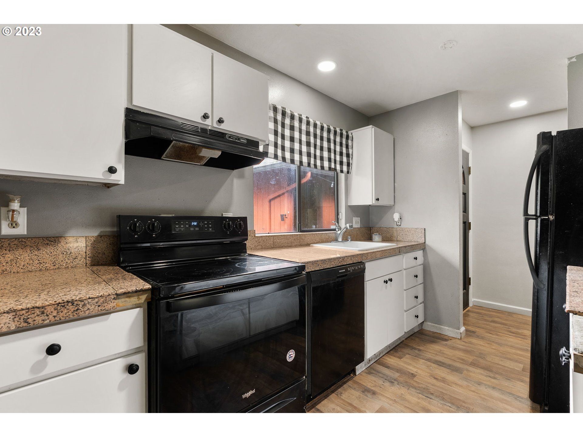 2720 Southeast Palmquist Road Gresham, OR 97080 - Photo 4 of 15 a kitchen with stainless steel appliances granite countertop a stove a sink and a refrigerator