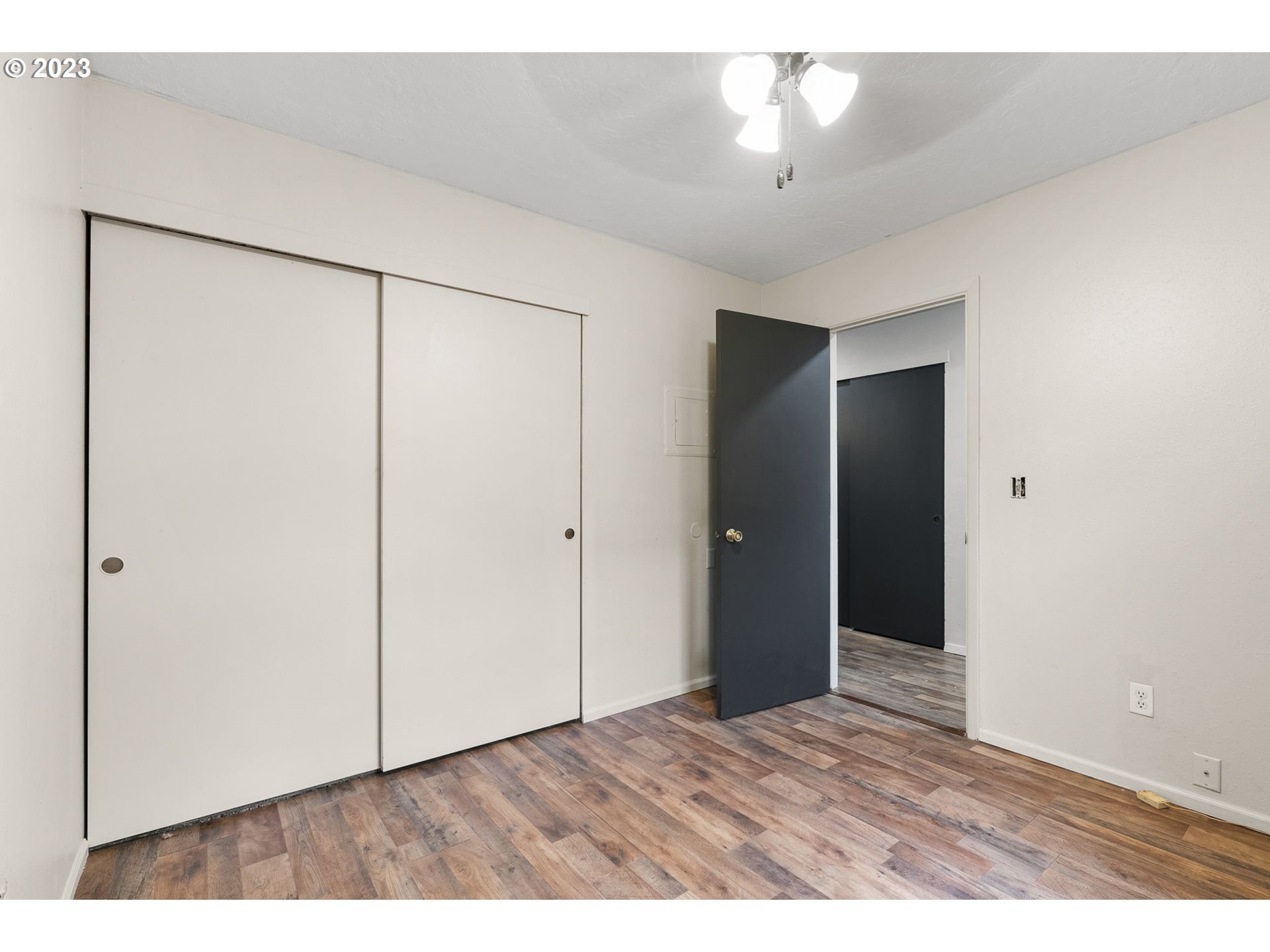 2720 Southeast Palmquist Road Gresham, OR 97080 - Photo 8 of 15 an empty room with closet and a chandelier fan