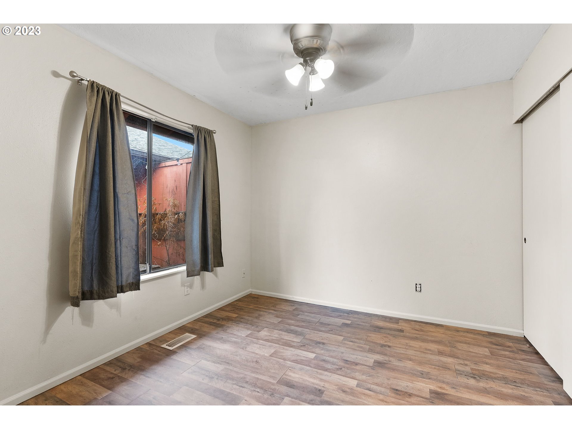 2720 Southeast Palmquist Road Gresham, OR 97080 - Photo 9 of 15 a view of an empty room with a window