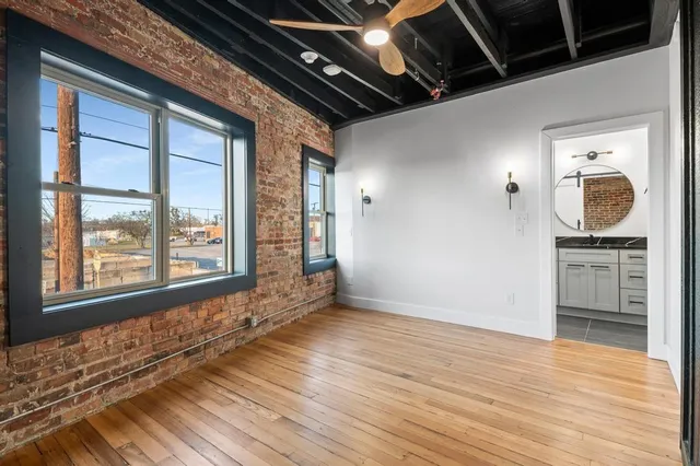 a bathroom with a granite countertop sink a mirror and a toilet