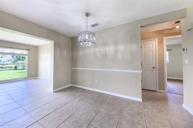 a large bedroom with a bed and furniture