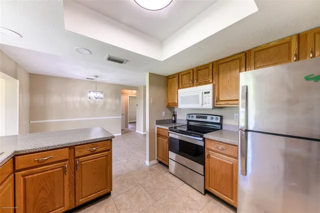 a utility room with cabinets washer and dryer