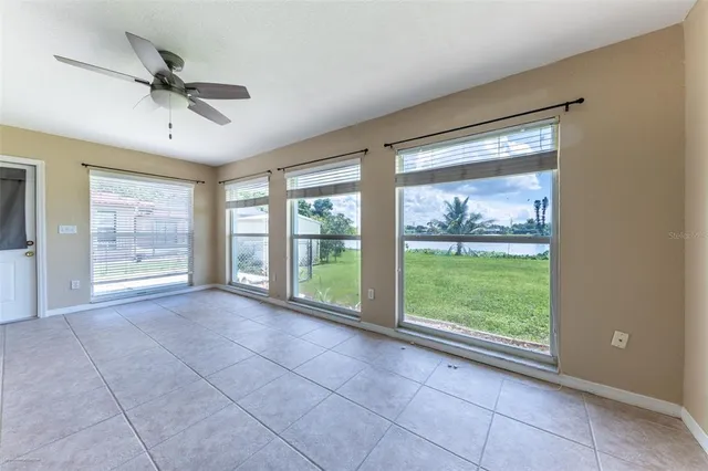 a view of a livingroom with a ceiling fan and window