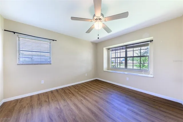 wooden floor in an empty room with a window