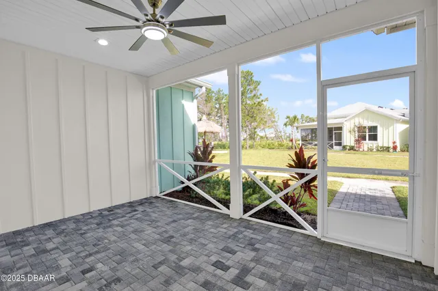 a front view of a house with a yard and plants