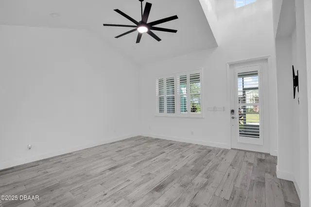 a kitchen with stainless steel appliances a dining table chairs and granite counter tops