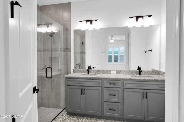 a bathroom with a granite countertop sink a toilet and shower