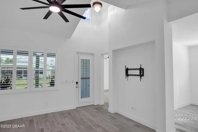 a kitchen with stainless steel appliances kitchen island refrigerator cabinets and wooden floor