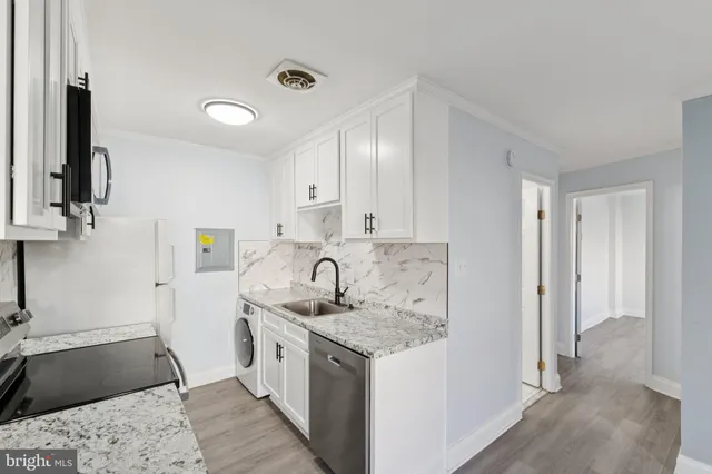 a kitchen with a sink stove and refrigerator